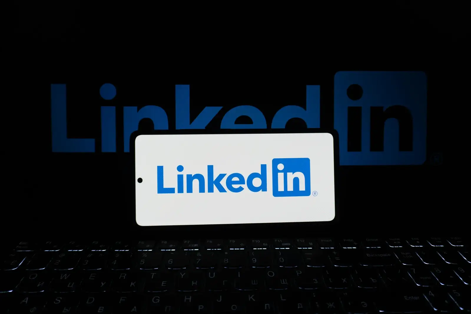 LinkedIn logo displayed on a smartphone and laptop for professional networking