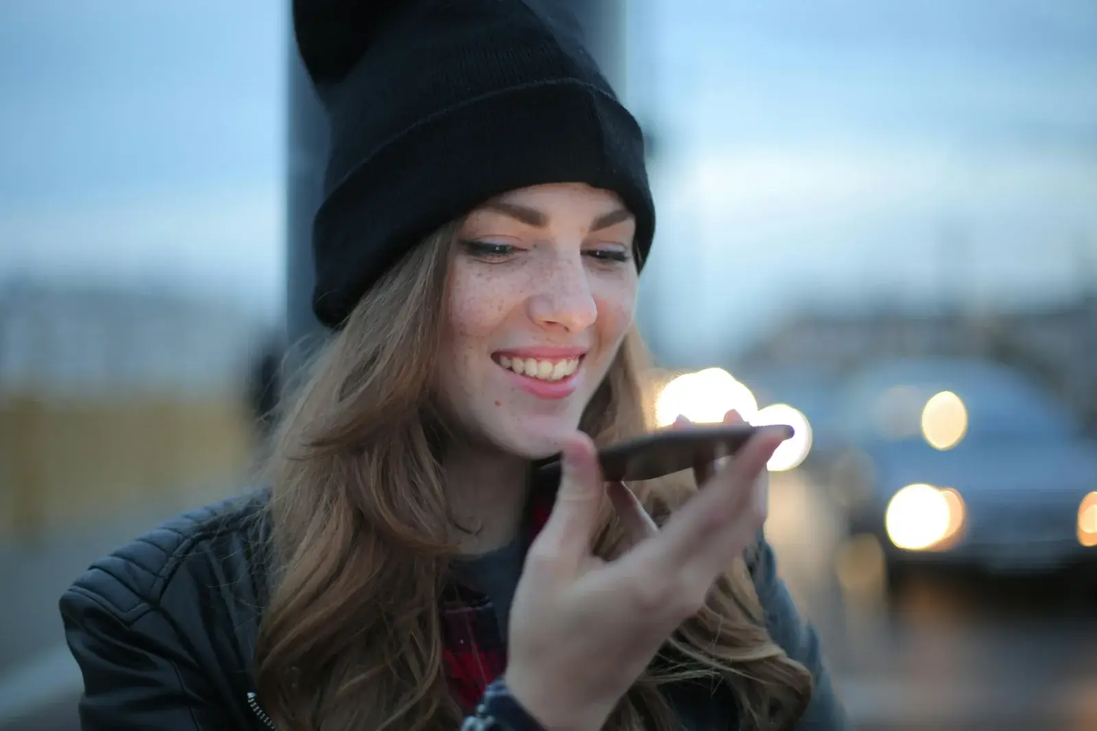 Woman using smartphone for voice and AI search optimization